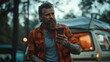 © Ruslan Gilmanshin - A bearded man stands in front of a van holding a cell phone