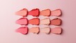 © JP STUDIO LAB - A stylish array of matte peach and beige lipstick swatches, side by side, creating a seamless ombre.