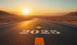 © Unslux - at sunset Road to 2025 with an empty road with written and arrow pointing towards the horizon to represent the future and positivity and success of the new year 2025 in a middle desert way