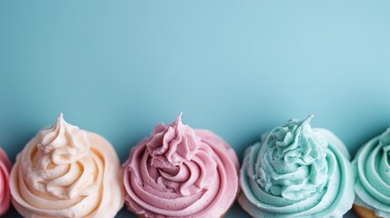 Wall Mural - A row of vibrantly colored cupcakes against a blue background, each with beautifully swirled frosting, representing sweetness, fun, and whimsy in a bright, cheerful display.