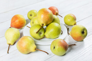 Wall Mural - Fresh pears on plate on wooden background. Selective focus