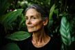 © yaqui_villegas - A serene portrait of an older woman surrounded by lush green foliage, her gaze relaxed and calm, highlighting the connection between humans and nature in vivid detail.