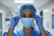 © Rufino - A woman in a blue scrubs is wearing a blue surgical cap and blue gloves