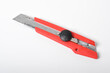 © Mulad Images - Red utility knife cutter isolated on white background. Stationery cutter knife