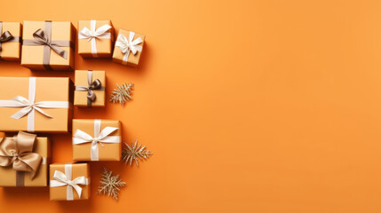 Top view of gifts, bows and Christmas decorations on a orange background