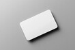 © Elizabeth - A mockup of a blank business card on a gray background, close-up, top view, with a soft shadow. Created with Ai
