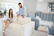 © Serhii - Couple chooses upholstered furniture in store