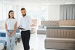 © Serhii - A professional sales consultant advises a client in a furniture store.