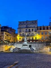 statue in front of beautiful architecture in lisbon city 