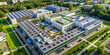 © janya - Aerial drone view of a hospital campus with sustainable practices including green roofs and solar panels for energy efficiency