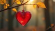 © Oleg Sevostyanov - A red glass heart hanging on a tree branch in the autumn forest. The concept of Valentine's Day
