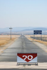 A runway with a visible distance marker indicating runway number and direction.