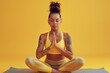 © Anjali - Woman in sportswear meditating in yoga pose on mat.