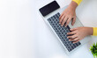© Thawatchai Images - Office desk clean and minimal working scene with businesswoman hands over a silver laptop keyboard on a white office table in workplace, Top view, Copy space.