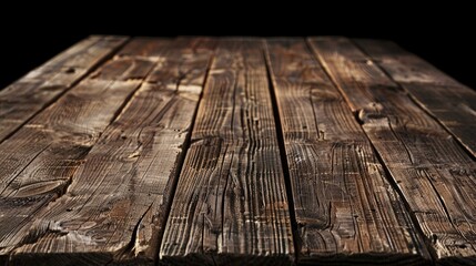 A close-up shot of a wooden table with a black background