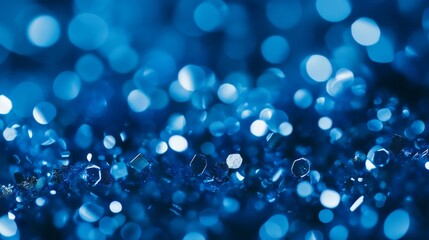 Wall Mural - Royal blue sparkles with sparkling sapphire glitters on a shimmering bokeh background. A wallpaper with crystal drops.