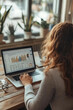© thien - A businesswoman is focused on analyzing sales report on her laptop, surrounded by plants in bright office space. data visualization on screen reflects her dedication to understanding performance metri