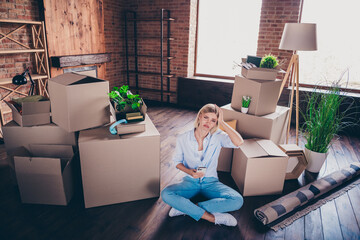 Poster - Full size high view photo of young woman sit floor upset moody hold device dressed shirt jeans move buy new cozy home interior living room