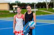 © Austockphoto - Two girl players from netball teams on the court holding ball