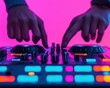 ©  Green Creator - DJ hands mixing music on a wired controller, colorful lights