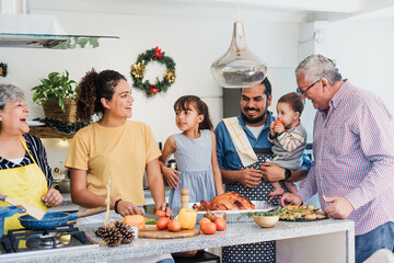 Wall Mural - Latin family cooking together for Christmas dinner at home in Mexico Latin America, hispanic mother, grandparents and daughter preparing turkey meat in holidays