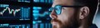 © Naphatson - Close-up of a man's face looking intently at a computer screen with stock market data.