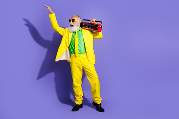 Sticker - Photo of crazy positive funny pensioner wear yellow stylish costume outfit listen music empty space isolated on purple color background