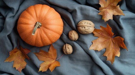 Sticker - A seasonal arrangement featuring a pumpkin, walnuts, and autumn leaves on a soft fabric backdrop.