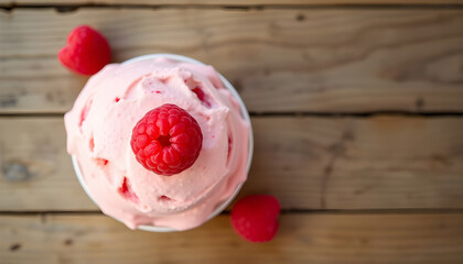 Raspberry ice cream on wooden table background.