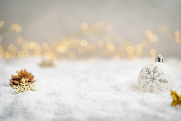 Wall Mural - christmas holiday background with snow, fir tree and decorations with christmas light behind. christ