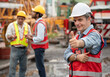 © chachamp - Thump up Mature caucasian engineer man worker with team and spare crane background