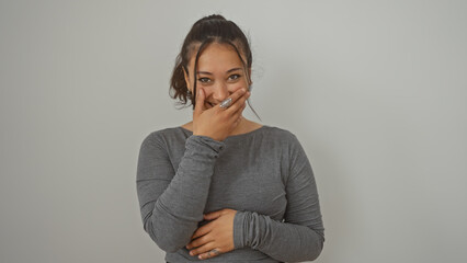 Poster - Portrait of a smiling young hispanic woman with a casual hairstyle standing against an isolated white background