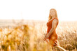 © Victoria - Beautiful  woman with freckles on her face portrait in a summer  field. Calm young woman in a field of wheat.