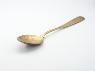 Ancient copper spoon on a white background