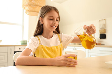 Sticker - Little girl pouring apple juice into glass in kitchen