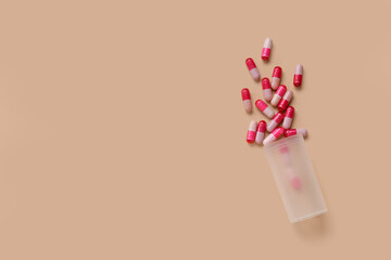 Sticker - Jar with scattered pills on beige background