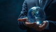 © Oleksiy - Global innovation. Businessman holding virtual planet on dark blue background, closeup