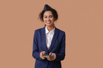 Sticker - Beautiful African-American stewardess with passport and ticket on beige background