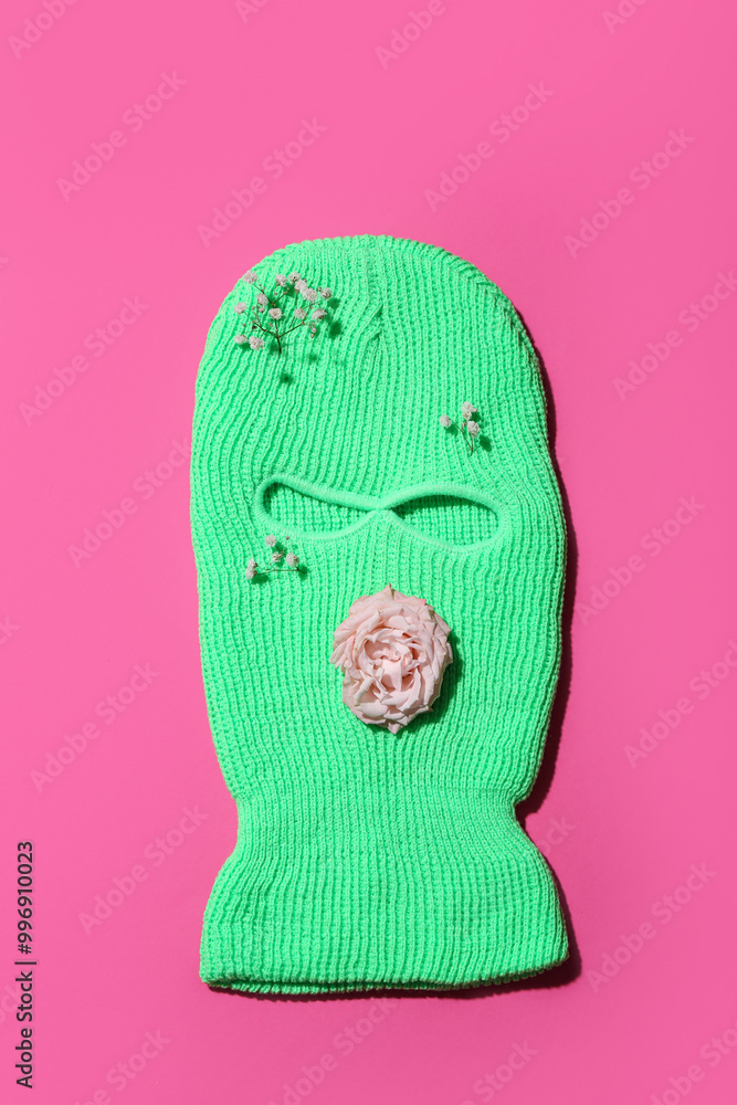 Green balaclava with flowers on pink background