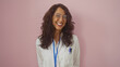 © Krakenimages.com - Smiling middle-aged hispanic woman with glasses and lab coat isolated against a pink background