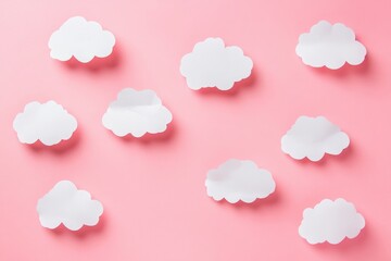 White paper clouds set against a pink background, flat lay with copy space for text or design