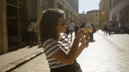 Wall Mural - Young hispanic woman enjoying gelato in the beautiful town of lecce, puglia, italy, highlighting her casual outfit and the charming european street setting.