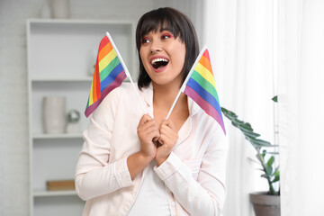 Wall Mural - Happy young woman with LGBT flags in bedroom