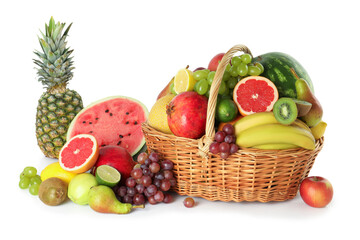 Poster - Many different fresh fruits in wicker basket isolated on white