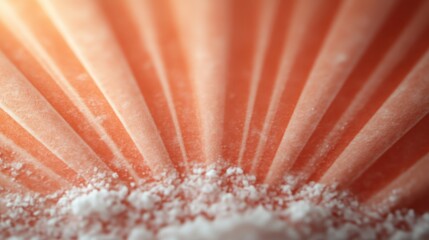 This image shows a close-up of white powder scattered across an orange radial background, creating an intriguing interplay between the rough and smooth textures while maintaining harmony.