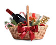 © New Africa - Wicker gift basket with wine and Christmas decor isolated on white