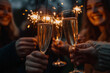 © S photographer - Closeup of people's hands holding fireworks and champagne glasses, celebrating the arrival of the new year, New Year's Eve party