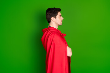 Poster - Side profile photo of serious guy dressed shirt red cloak hold arms folded look at logo empty space isolated on green color background