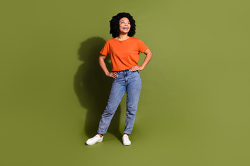 Wall Mural - Full body photo of attractive young woman posing look empty space dressed stylish orange clothes isolated on khaki color background