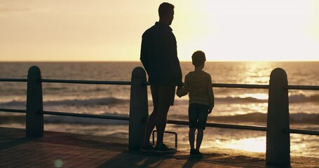 Sticker - Family time by the ocean holding hands, father and child watching the sunset view while standing on the pier at the beach. Child holding dads hand at promenade trust, love and support by the sea.